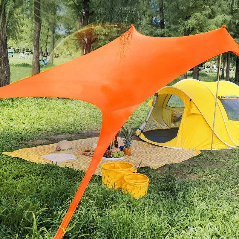 Blauwe zonnescherm tent met metalen stokken biedt schaduw op het strand. Een vrouw in bikini en strohoed ligt op een ligstoel onder de tent, perfect v