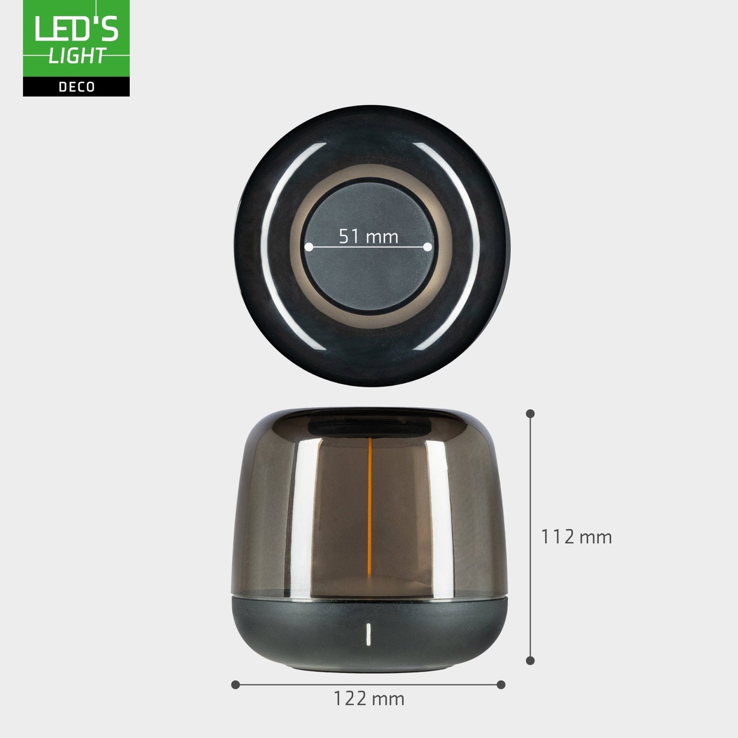 Een moderne, transparante LED-lamp met warm wit licht en een zwarte basis, geplaatst naast haar groene verpakking. Ideaal voor sfeerverlichting in woonkamer of slaapkamer.