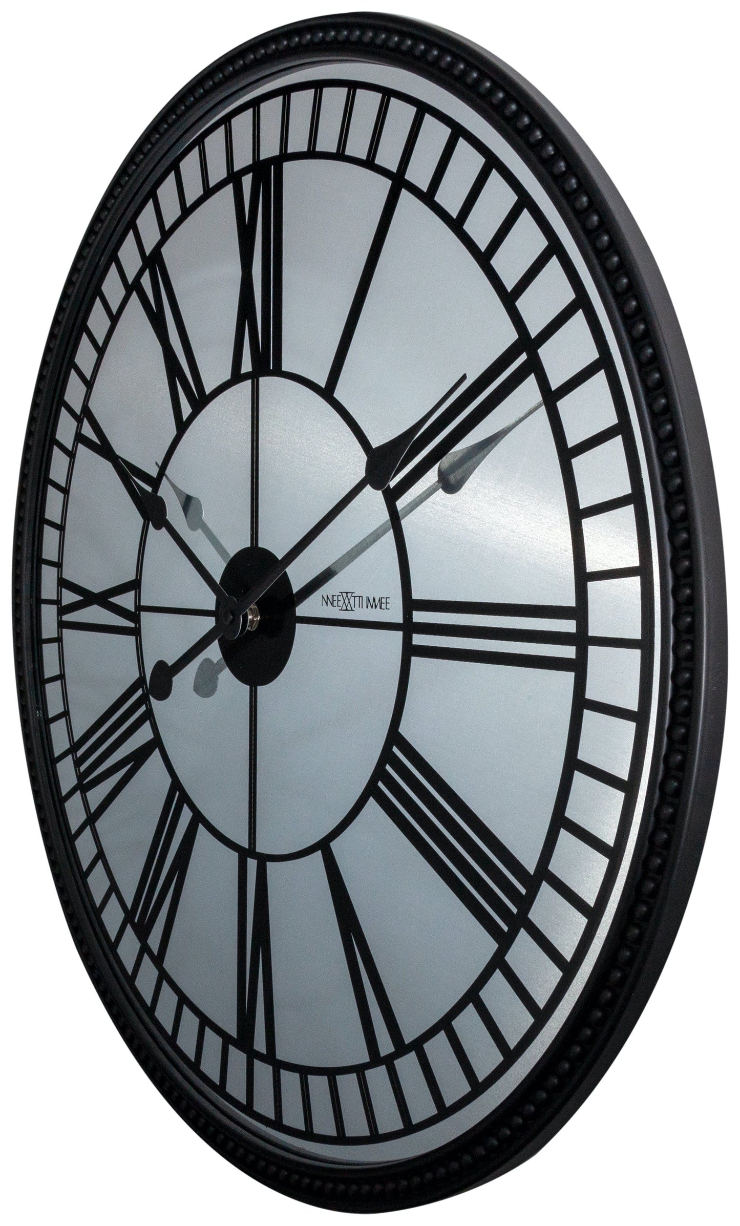 Een klassieke wandklok met zwart metalen kader en witte wijzerplaat met Romeinse cijfers. De wijzers en het merk ‘NEXTIME’ zijn duidelijk zichtbaar, geschikt voor woonkamer of kantoor.