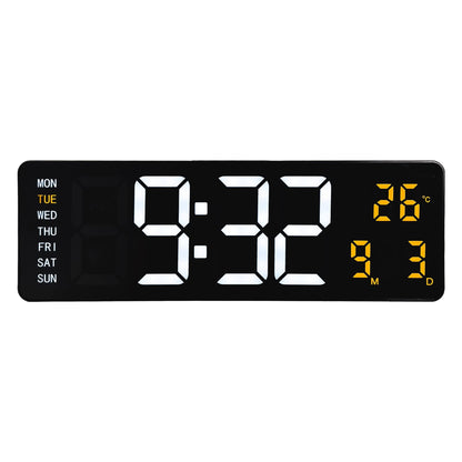 Een zwarte digitale wekker met witte tijd- en gele temperatuurweergave, toont 9:32 en 26°C. Inclusief dag van de week en datum, ideaal voor kantoor of slaapkamer.