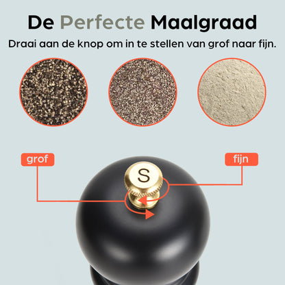 Zwarte houten pepermolen en zoutmolen met goudkleurige doppen, geplaatst op een zwarte standaard met het merk 'hermanos'. Inclusief vier vervangende doppen voor keukengebruik.