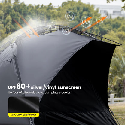 Zilveren vinyl zonnescherm met UPF60+ bescherming, geplaatst op het strand met twee vouwstoelen en tafel. Ideaal voor zonbescherming tijdens kamperen 
