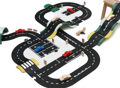 De Waytoplay King of the Road speelset bestaat uit 40 zwarte wegplaten met witte verkeersmarkeringen, geschikt voor creatieve speelplekken en speelruimte voor kinderen.