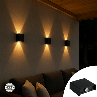 Zwart wandlamp met warm wit licht, geïnstalleerd in een moderne tuinruimte. Geschikt voor buitenverlichting en sfeerverlichting op terras of patio.