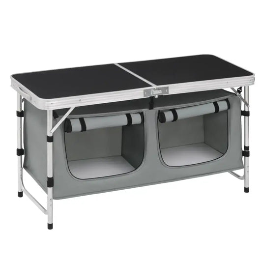 Zwart oppervlak met aluminium frame en grijze opbergzakken voor kampeer- en caravangebruik. Compacte, vouwbare tafel met twee vakken voor opslag tijdens reizen.