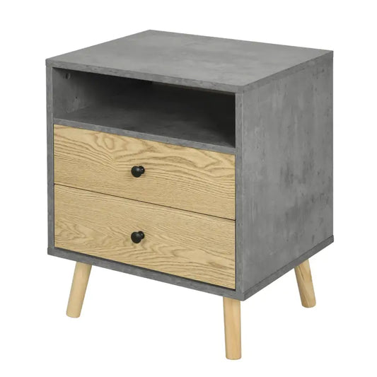Een modern nachtkastje met grijze betonlook en lichte houten laden, voorzien van zwarte knoppen en houten poten. Ideaal voor slaapkamerdecoratie en nachtkastje met opbergruimte.