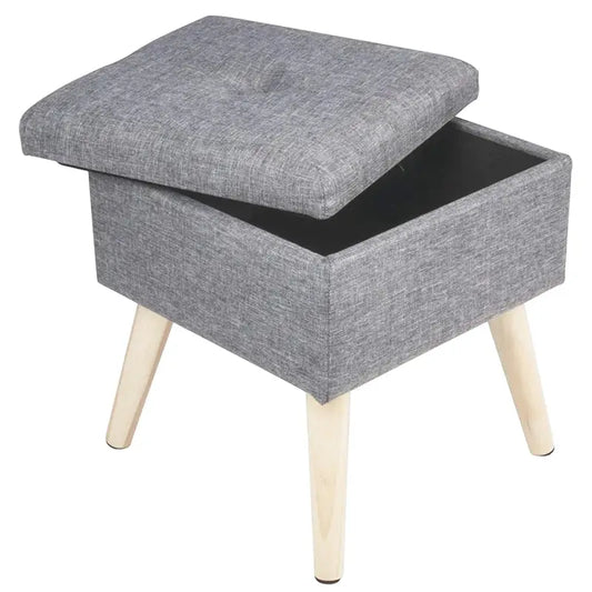 Grijze, gestoffeerde kruk met knop in het midden en lichte houten poten, geschikt als opbergruimte voor woonkamer of slaapkamer. Modern design voor comfort en stijl.