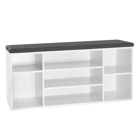 Een witte, modulare opbergkast met een donkergrijze zitbank, geschikt voor woon- of kantoorruimte. De open vakken bieden ruimte voor boeken, decoratie of kantoorbenodigdheden.