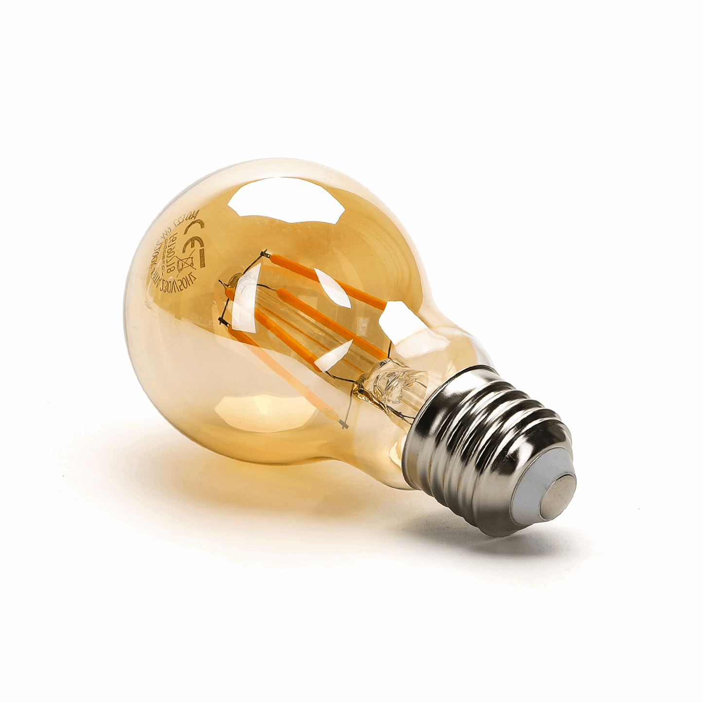 Zes glazen filamentlampen met warm wit licht, zichtbare koperen draden en zilverkleurige E27-schroefdraad. Perfect voor vintage interieurs of sfeerverlichting in woon- en werkkamers.