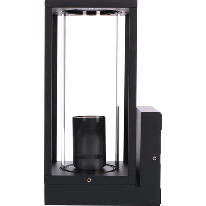 Een zwart, rechthoekig buitenspot met glazen panelen en een gloeiende filamentlamp. De warme verlichting werpt zachte schaduwen op de muur, ideaal voor tuin- of terrasverlichting.