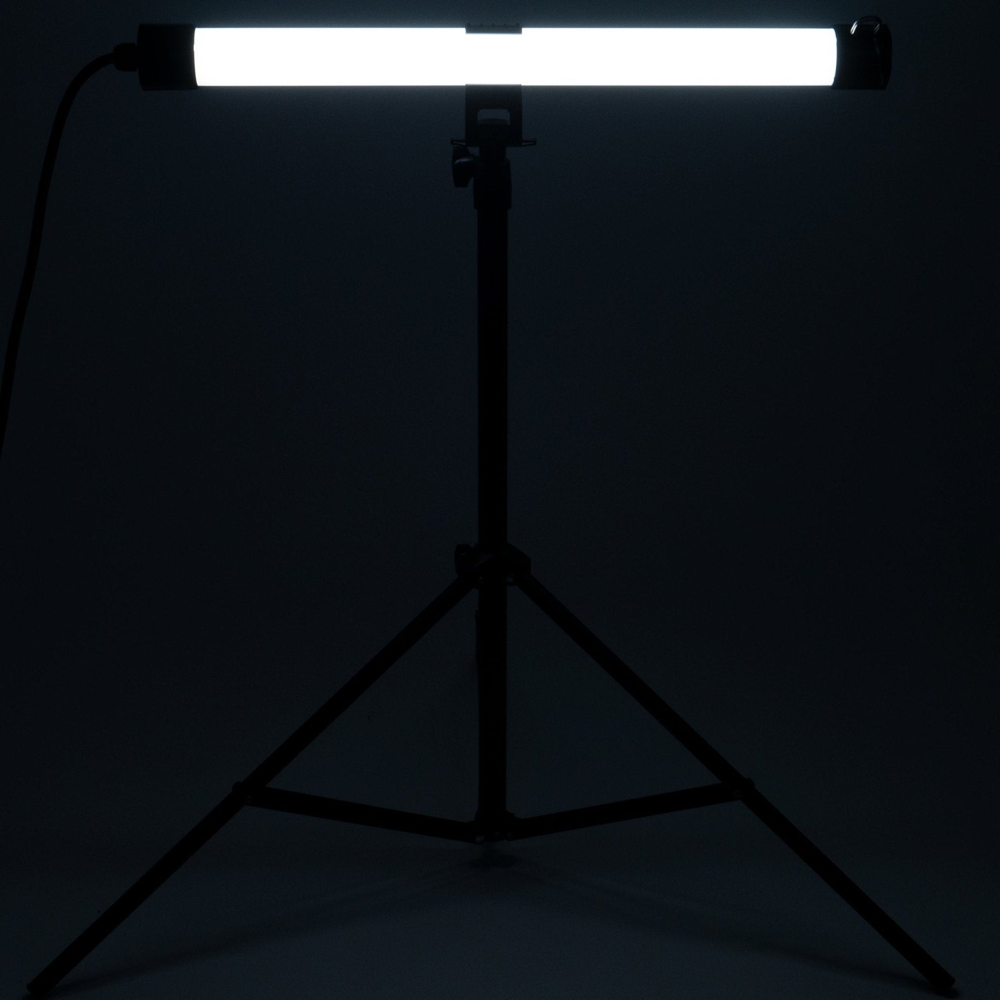 Zwart fotolampenstatief met opgehangen LED-balk, geschikt voor studio- en productfotografie. Stabiele driepootconstructie met verstelbare hoogte en kabel voor professionele belichting.