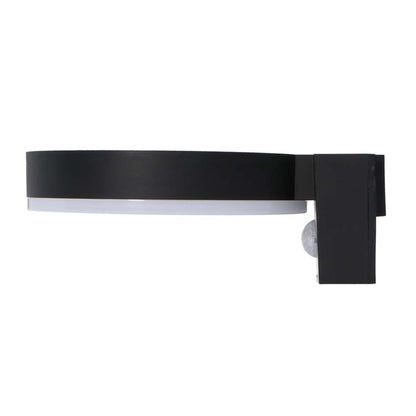 Een moderne, zwarte ringvormige wandlamp met warm wit licht, geïnstalleerd op een textuurrijke bakstenen muur. Uitgerust met bewegingssensor en touch-knop voor buitenverlichting.