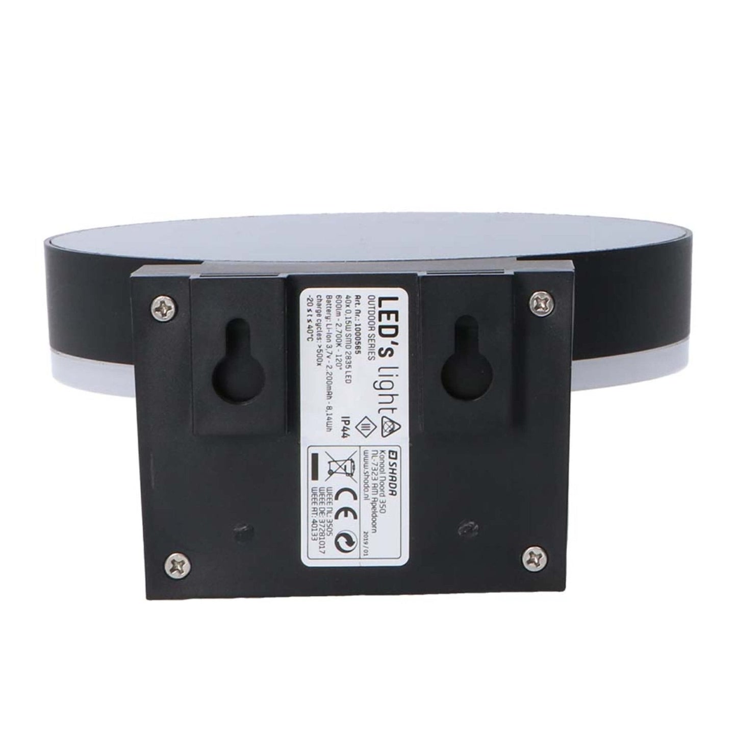 Een moderne, zwarte ringvormige wandlamp met warm wit licht, gemonteerd op een textuurrijke bakstenen muur. Uitgerust met bewegingssensor en aan/uit knop voor automatische verlichting in de entree of gang.