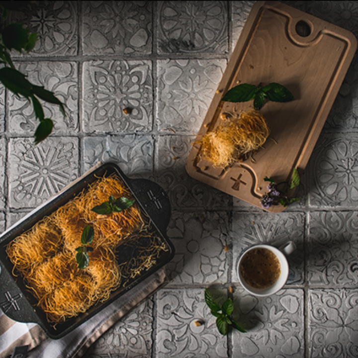 Zwart gietijzeren bakje met handvatten en gegraveerd logo, geschikt voor oven- en grilltoepassingen. Robuust ontwerp voor professionele en thuiskeuken gebruik.