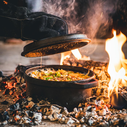 Zwarte kookpan van gietijzer met afsluitende deksel, voorzien van handvatten en het opschrift ‘Designed in Holland’. Ideaal voor koken op de kookplaat of in de oven.