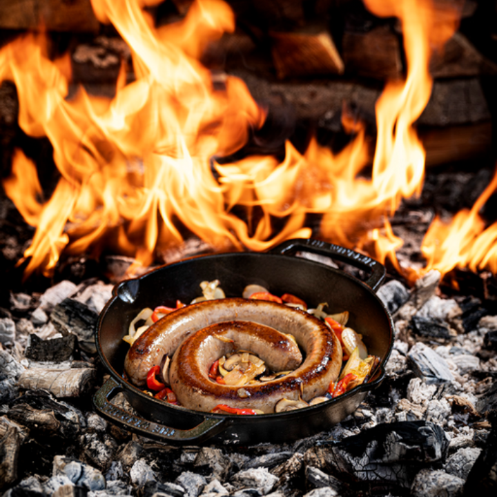 Zwarte, glanzende kookpan van gietijzer met twee handvatten en het merklogo. Geschikt voor grillen en bakken op elke kookmethode, inclusief oven en gas.