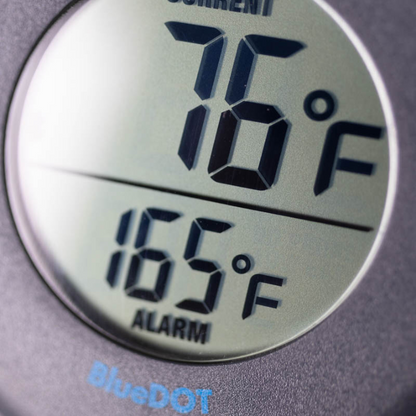 Zwart ronde BlueDOT thermometer met digitale display, toont huidige temperatuur 76°F en alarm 165°F. Bluetooth-icoon en bedieningsknoppen zichtbaar voor gebruik in keuken of op kookplaat.