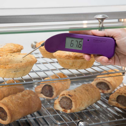 Een paarse digitale vlees thermometer met zichtbare schermweergave van 20,7°C en een metalen meetstok. Geschikt voor nauwkeurige temperatuurmeting bij het koken van vlees en andere gerechten.